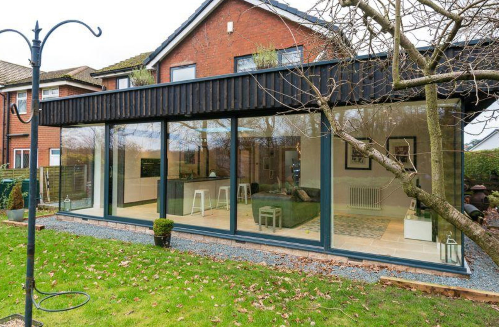Contemporary clad rear house extension with full-height glazing